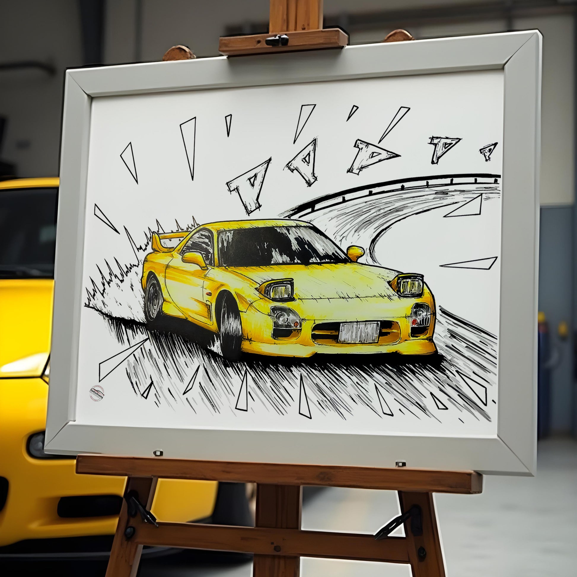 initiald mazda rx7 poster in frame in front of the yellow rx7 car