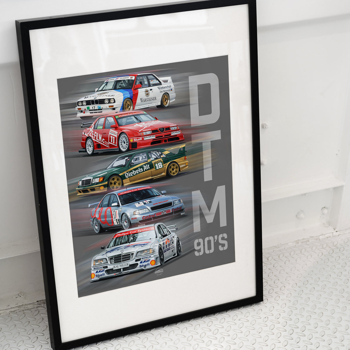 Framed poster of vintage DTM race cars from the 1990s on a white surface placed in black frame