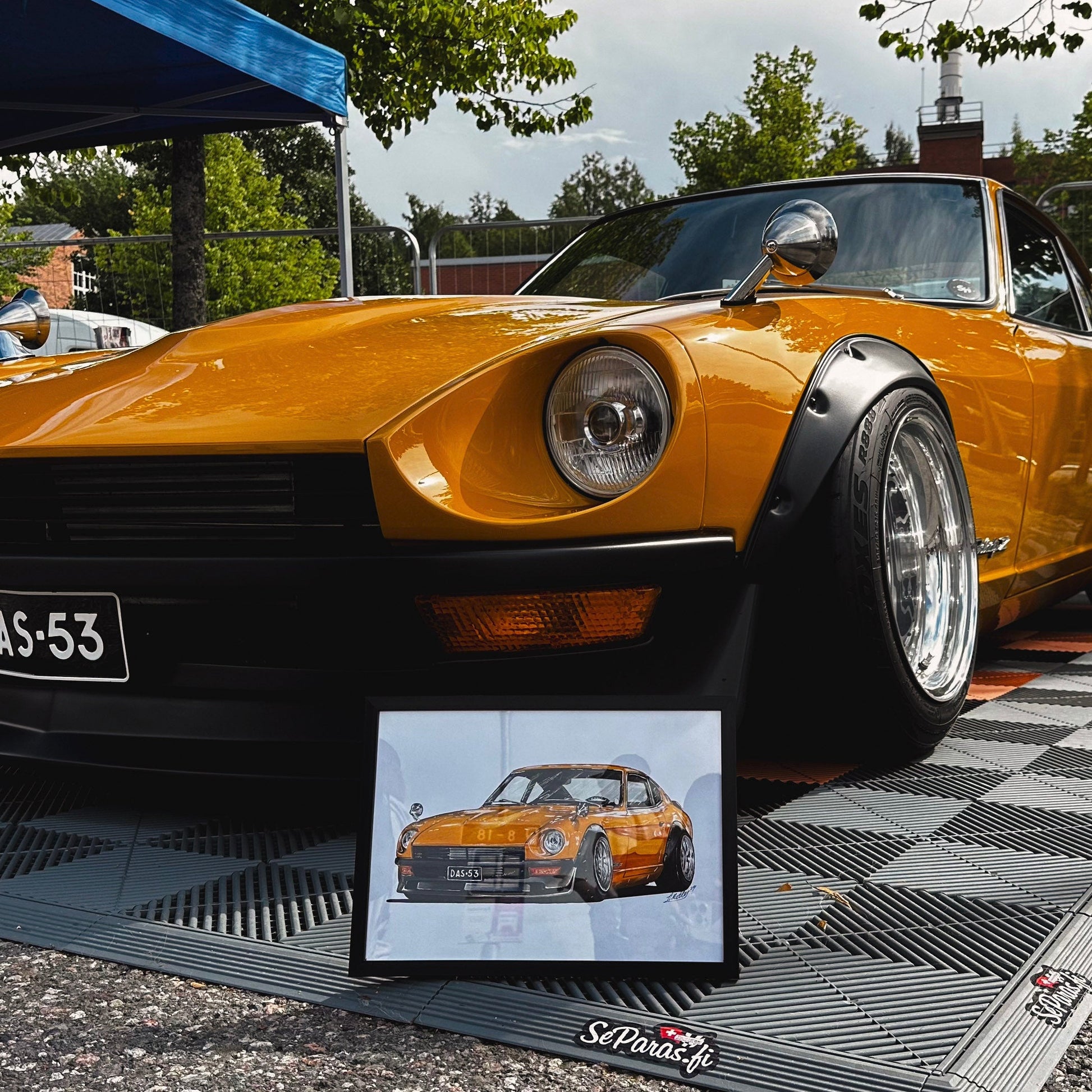 Yellow sports car on a checkered platform with a smaller inset image of the car.