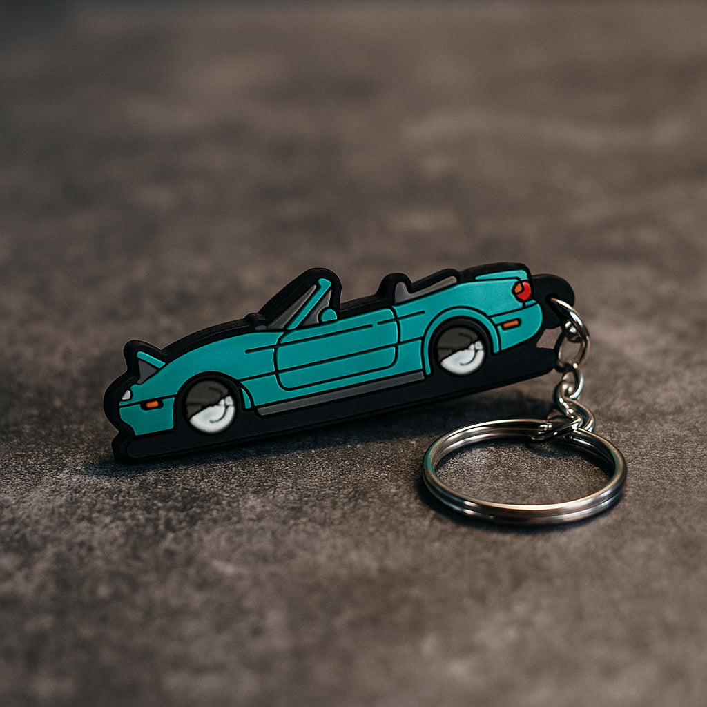 Car-shaped keychain on a textured surface