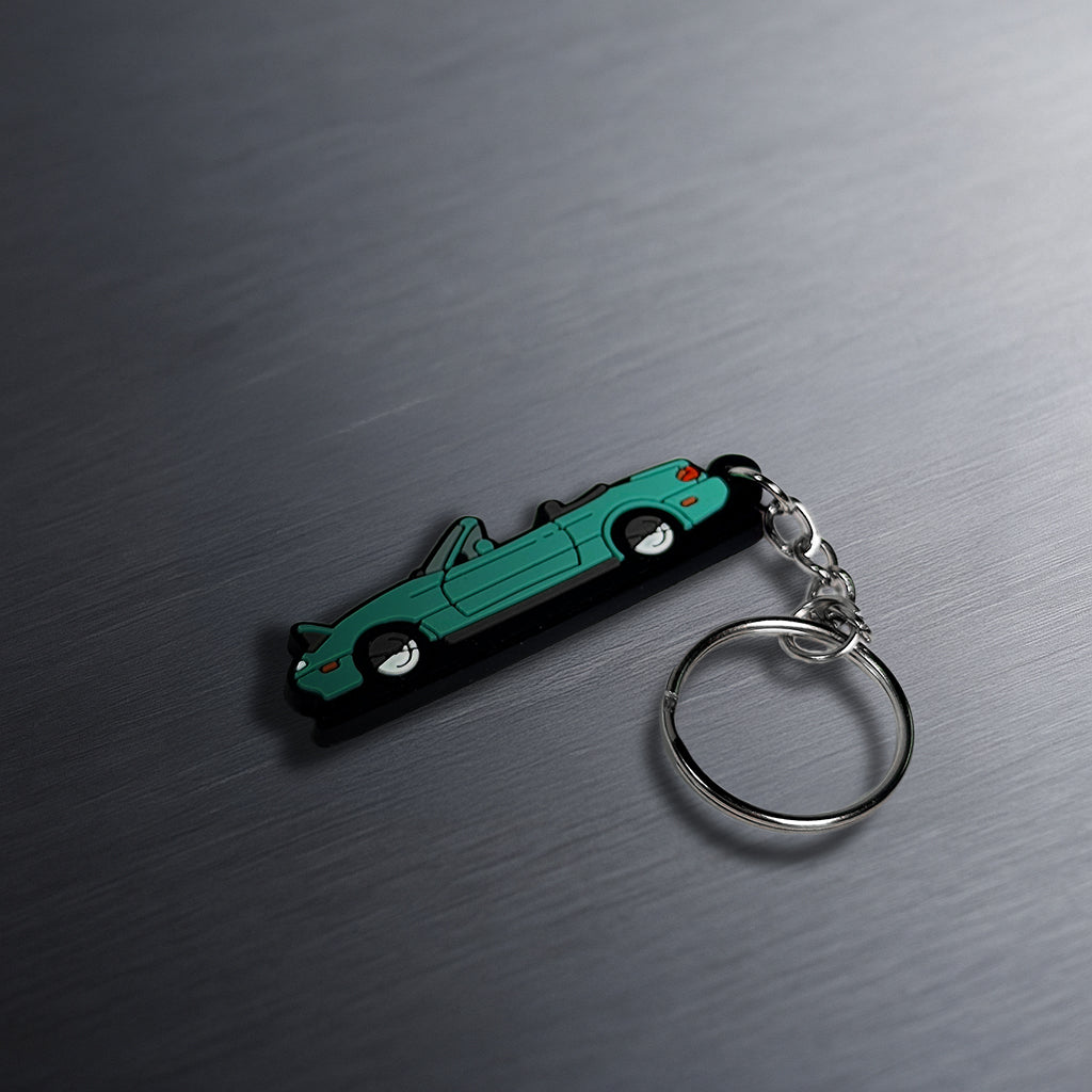 miata keychain on table
