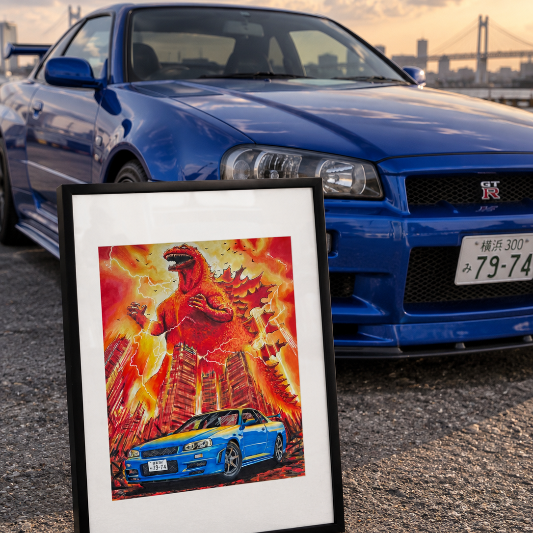 A framed art print featuring a stylized illustration of a blue Nissan Skyline R34 and a red Godzilla monster amidst flames, leaning against a blue Nissan R34 car on a gravel surface at sunset.