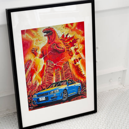 A framed art print featuring a blue Nissan Skyline R34 in front of a fiery red and orange Godzilla scene, displayed against a white wall on a textured gray floor.