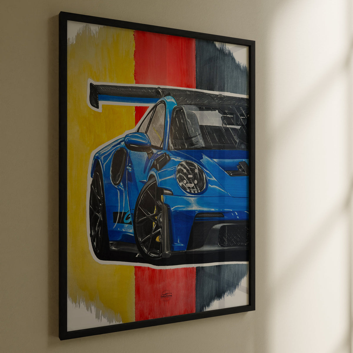Framed Porsche GT3RS darawing hanging on wall in black frame
