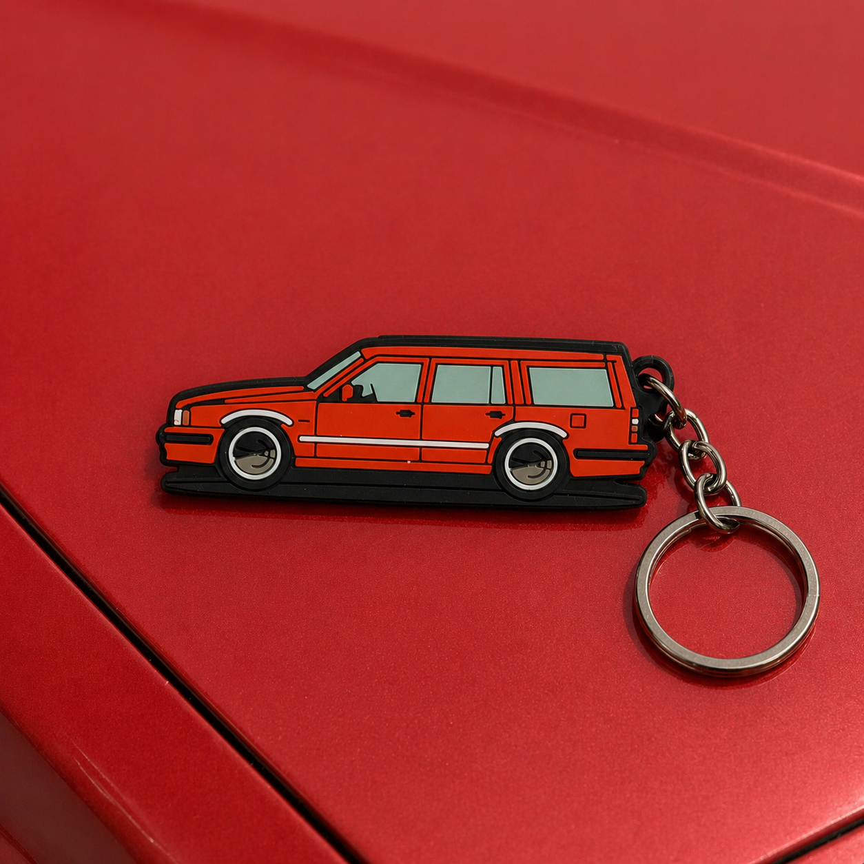 Volvo Keychain red car on a red surface